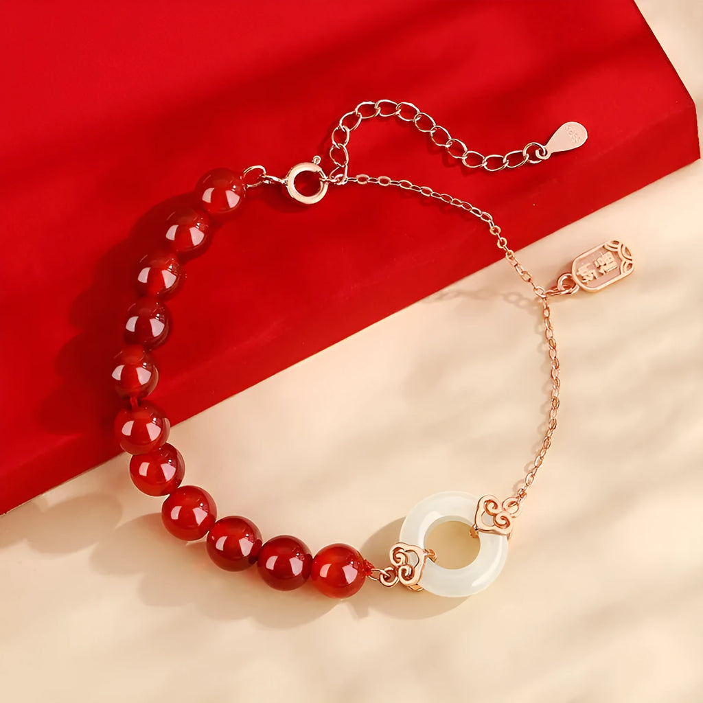 Close-up of a women's sterling silver bracelet with a peace buckle and engraved Chinese cloud and character motifs.