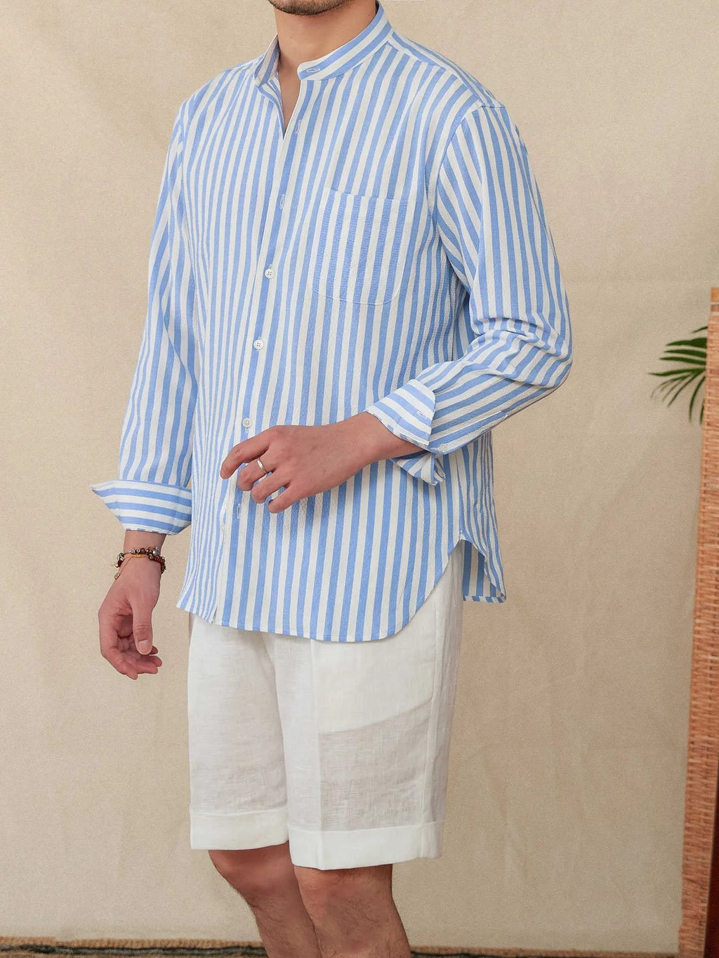 Blue and white seersucker striped long sleeve shirt with a loose lapel and baseball collar.