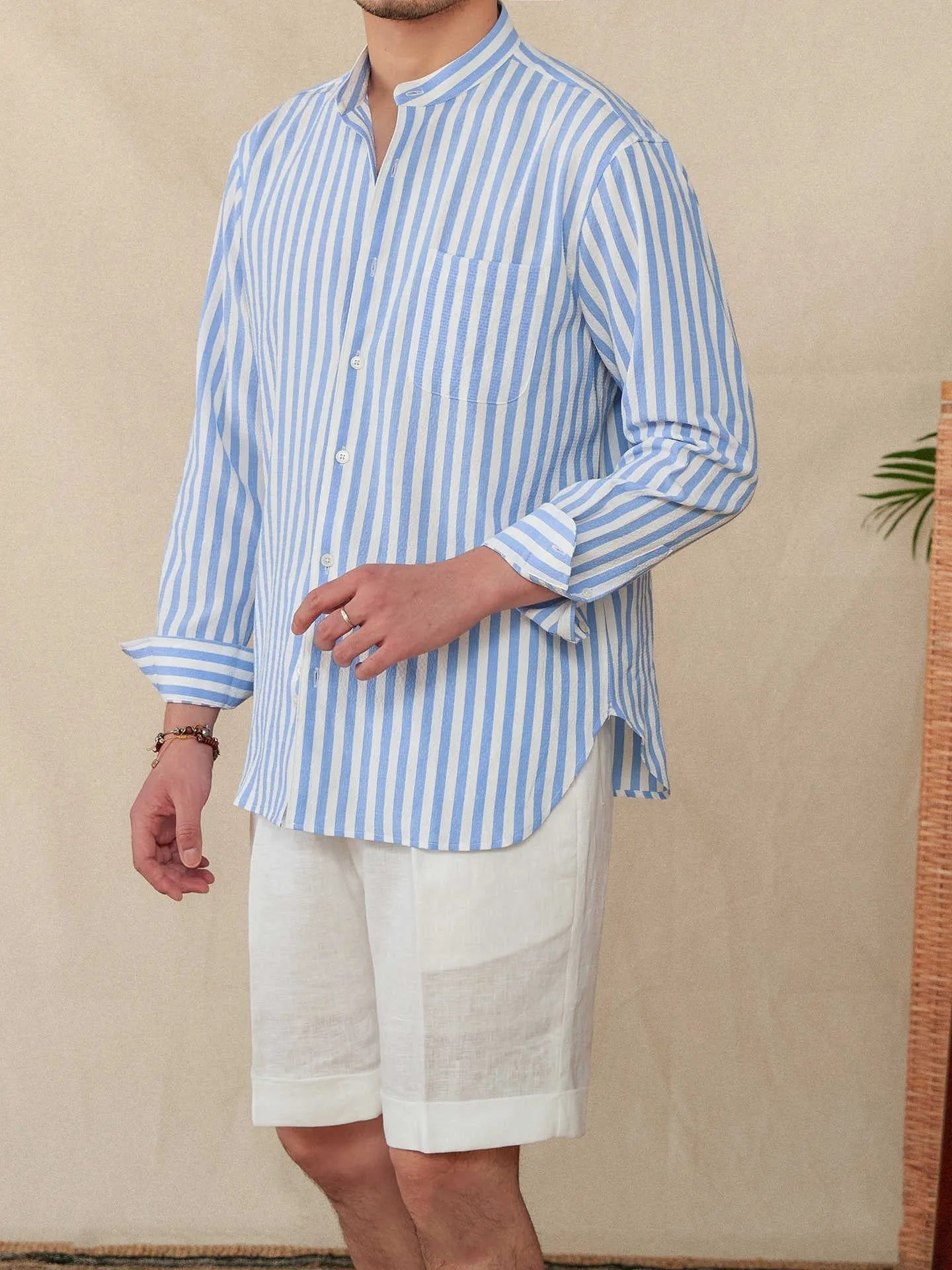 Blue and white seersucker striped long sleeve shirt with a loose lapel and baseball collar.