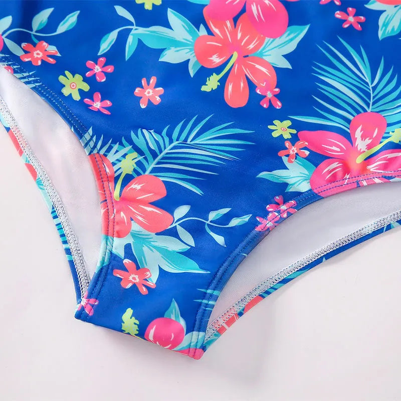 Girl's long-sleeve one-piece swimming suit in briefs style made from polyester fabric