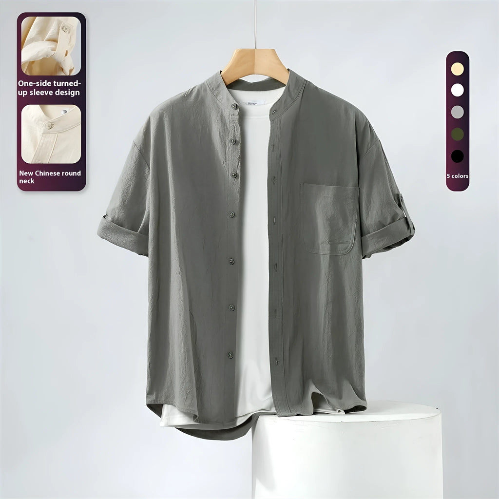 A man's loose-fitting, short-sleeved linen shirt in a solid colour with a stand collar.
