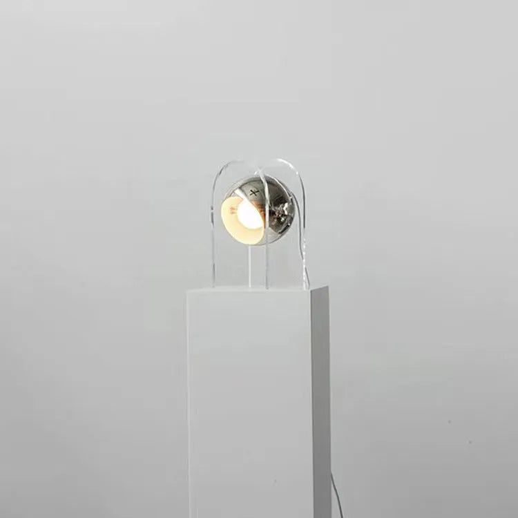 Modern minimalist acrylic table lamp with wrought iron base, 190x330mm, on a bedside table