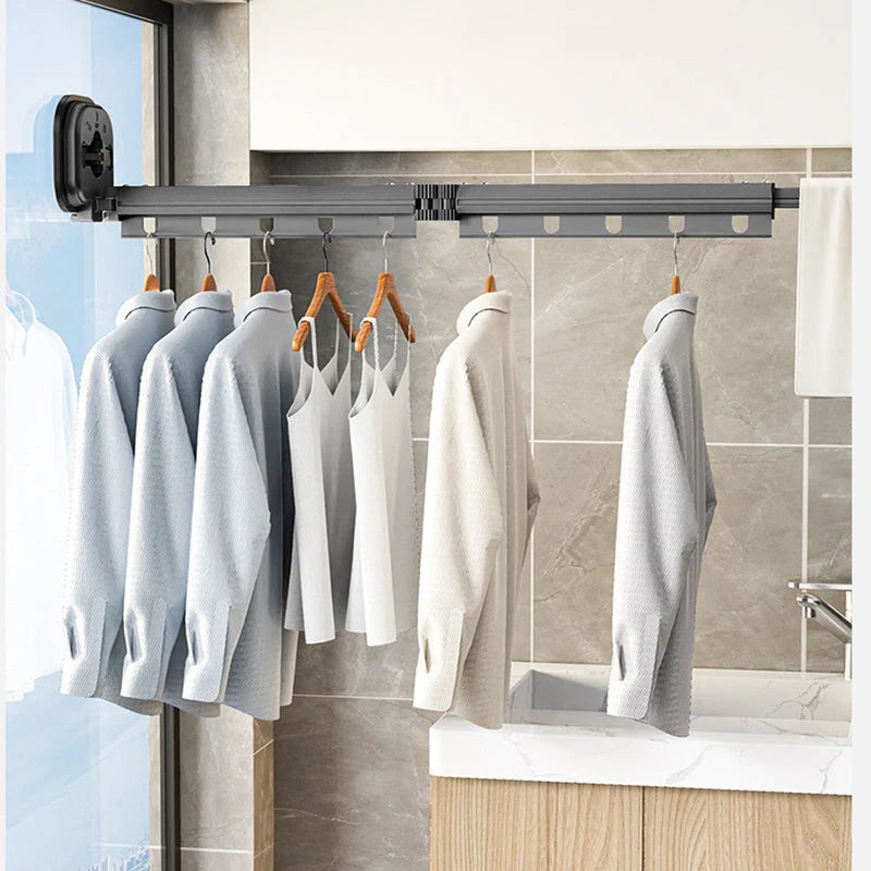 Aluminum retractable clothes drying rack mounted on wall with suction cups