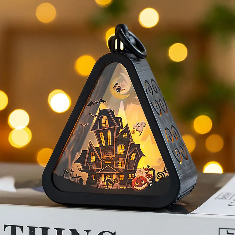 Portable Halloween pumpkin lamp decoration in choice of four colours on a table.