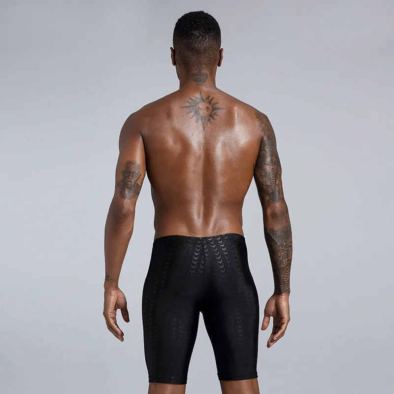 Men's solid colour polyester swimming trunks for surfing and beach use in sizes XL to 4XL