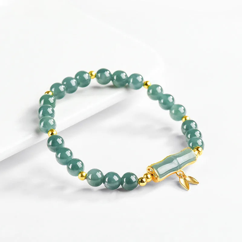 Blue water natural jade beads on a sterling silver high-rise bracelet for women.