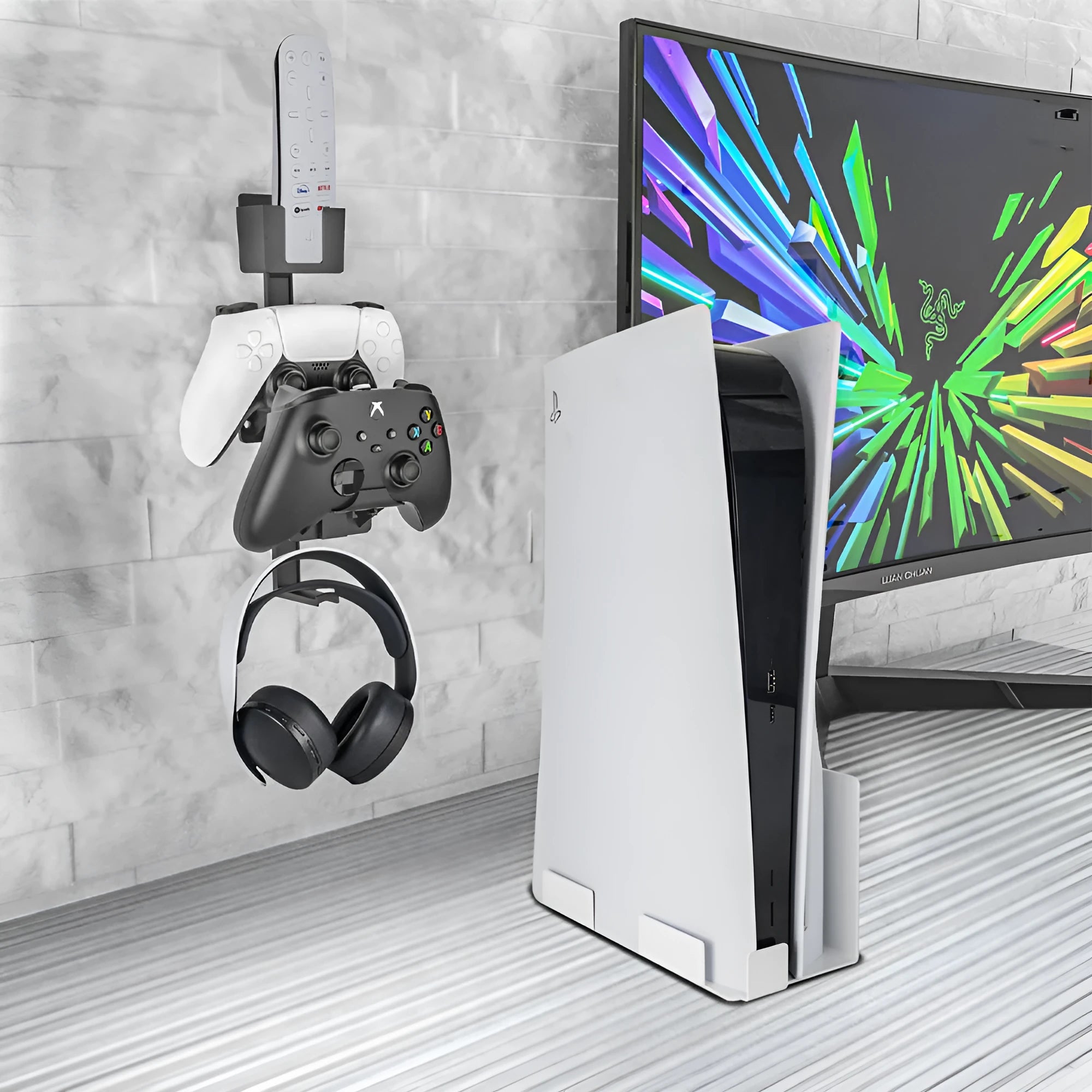 White and black wall-mounted plastic storage hook for gaming remote controls and headsets.