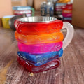 A synthetic resin decorative cup with a painted bookmark design, standing 13cm tall on a 10cm square base.