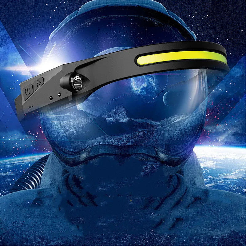 Black silicone USB-rechargeable headlamp with a wide COB LED lens and a side wave sensor.