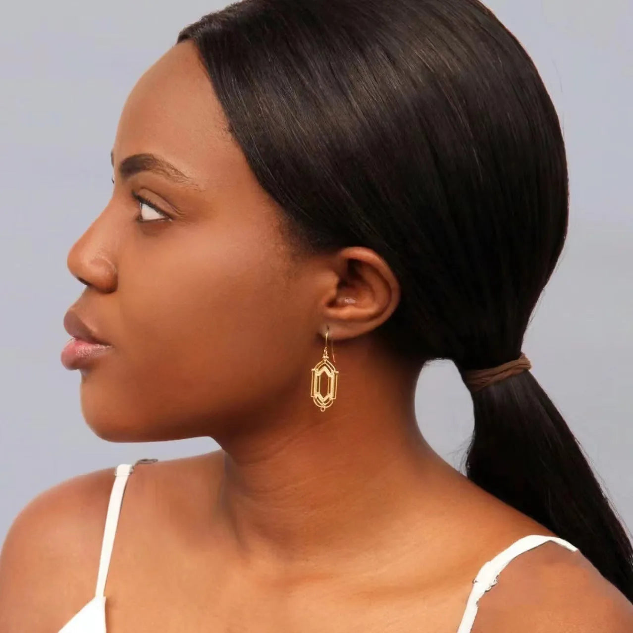 Gold flower window hollow stud earrings with geometric copper design and electroplated brass-style finish