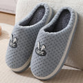 Rabbit plaid design artificial fur house slippers with a non-slip rubber sole.