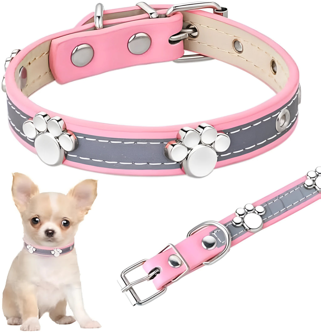 Reflective soft PU leather dog collar with metal buckle and decorative paw print rivets on a grey background.