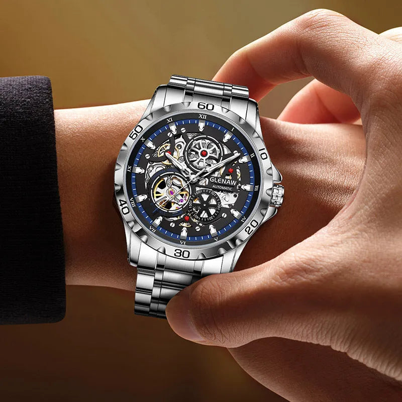 Men's silver skeleton automatic watch with luminous blue steel band and transparent case back