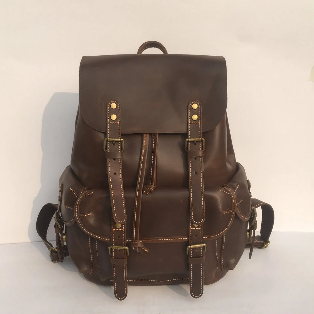 Brown men's leather backpack with an air pillow belt on the straps.
