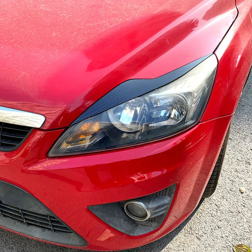 Pair of ABS plastic headlight eyebrow stickers for Ford Focus in carbon fibre pattern finish