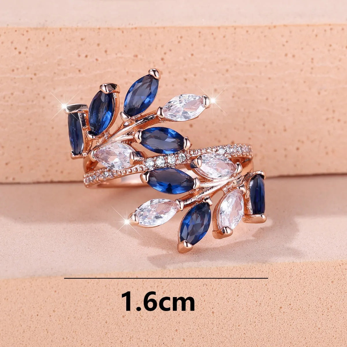 Adjustable copper leaf ring with a zircon stone in a choice of rose gold or platinum finishes.