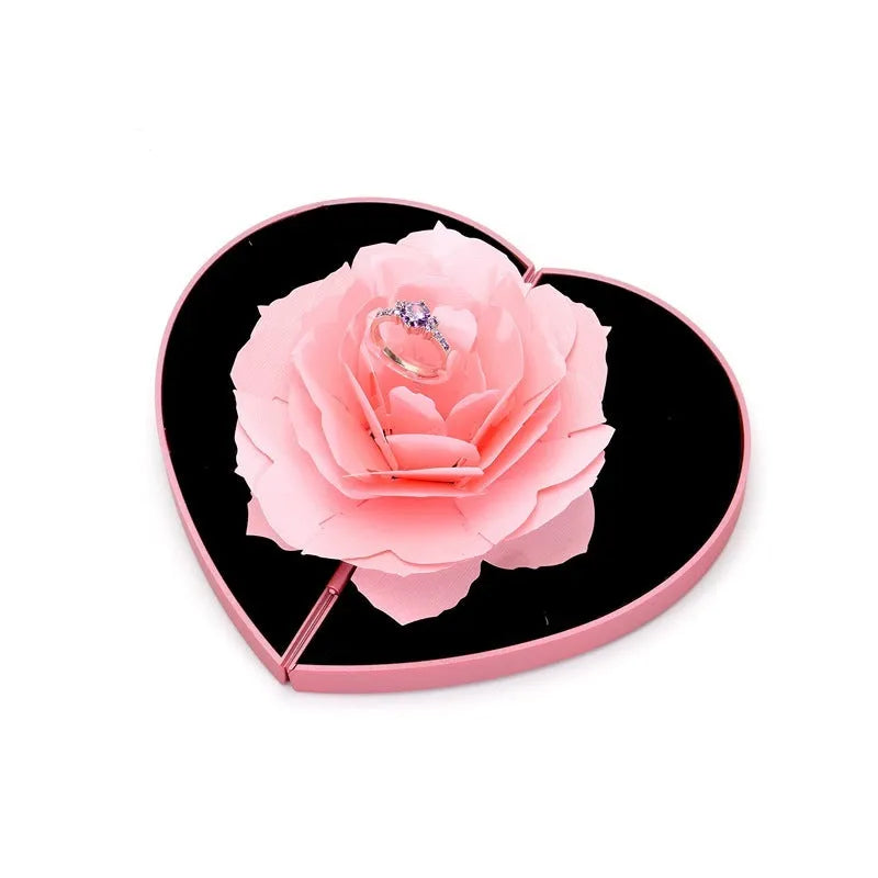 Red 3D heart-shaped rotating ring box with a rose flower decoration, open to show ring placement.
