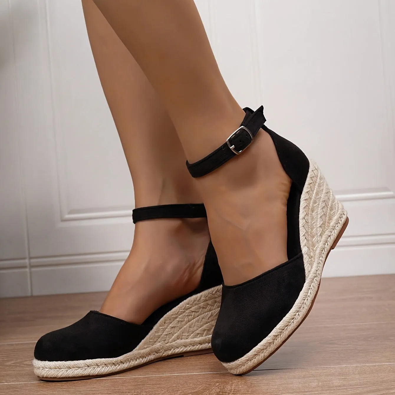 Women's apricot and black suede Roman-style wedge sandals with buckle and rubber sole.
