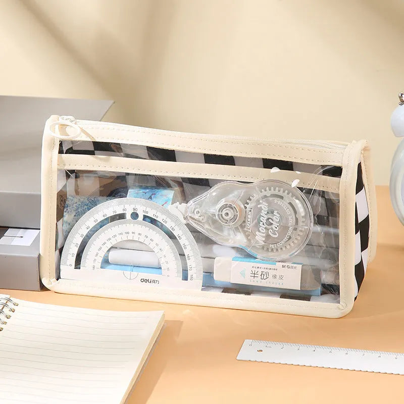 Transparent PVC pencil case showing internal chessboard grid pattern, measuring 21.5cm long.