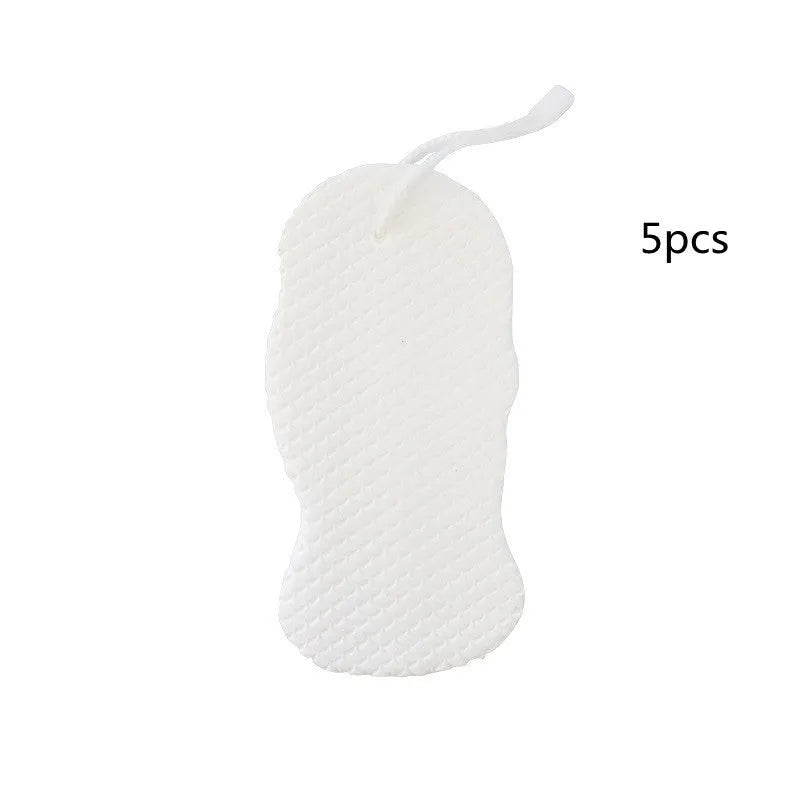 White 3D fish scale pattern bath sponge ball on a bathroom surface.