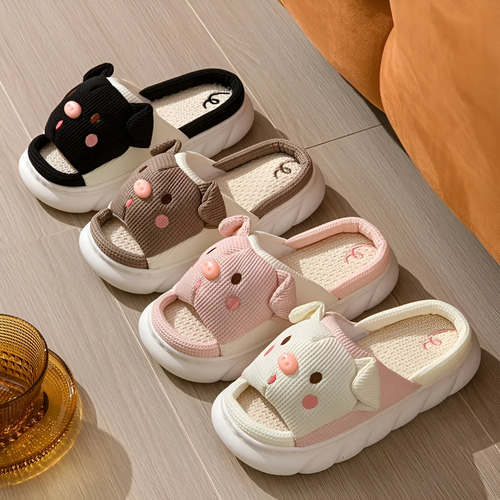 A pair of open toe linen slippers for couples on a light background, showing the flip-flop style and linen upper texture.