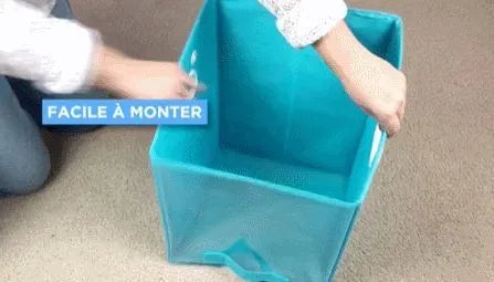 Blue folding storage basket with clear front panel shown on a shelf, folded flat and in use.