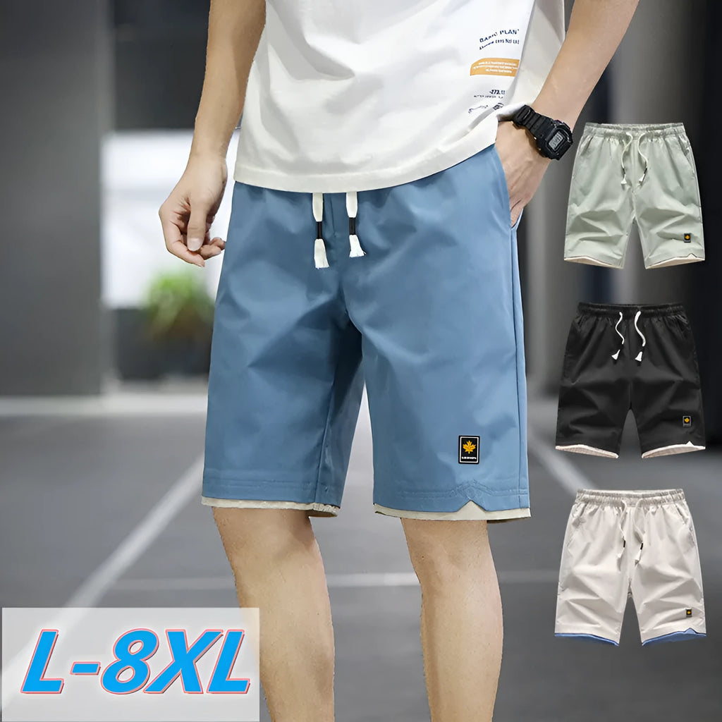 Casual straight-leg loose shorts in green polyester fabric on a neutral background.