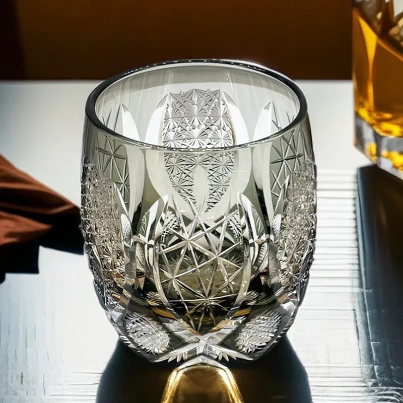 Four Japanese-style Edo crystal glass whisky tumblers in amber and clear cut-glass designs placed in wooden box