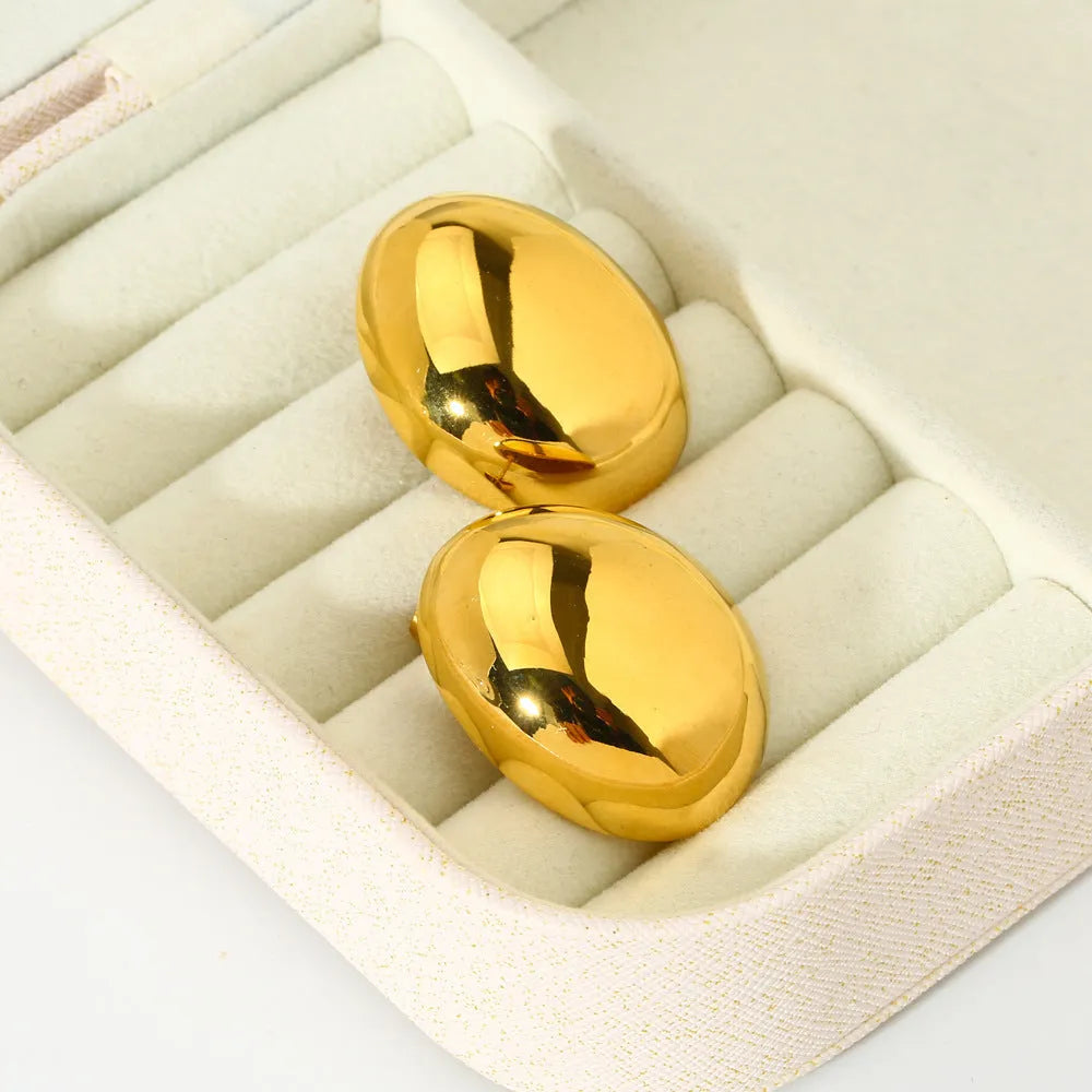 Geometric line design ear studs with stainless steel and 18K plating showing exaggerated glazed surface