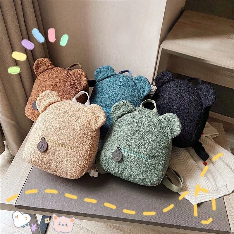 Cute, bear-shaped backpack made of soft, fleece material in various colors for casual travel and daily use