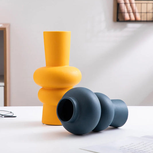 Nordic minimalist ceramic vase in blue, yellow, and orange with glazed finish