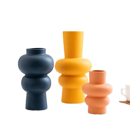 Nordic minimalist ceramic vase in blue, yellow, and orange with glazed finish