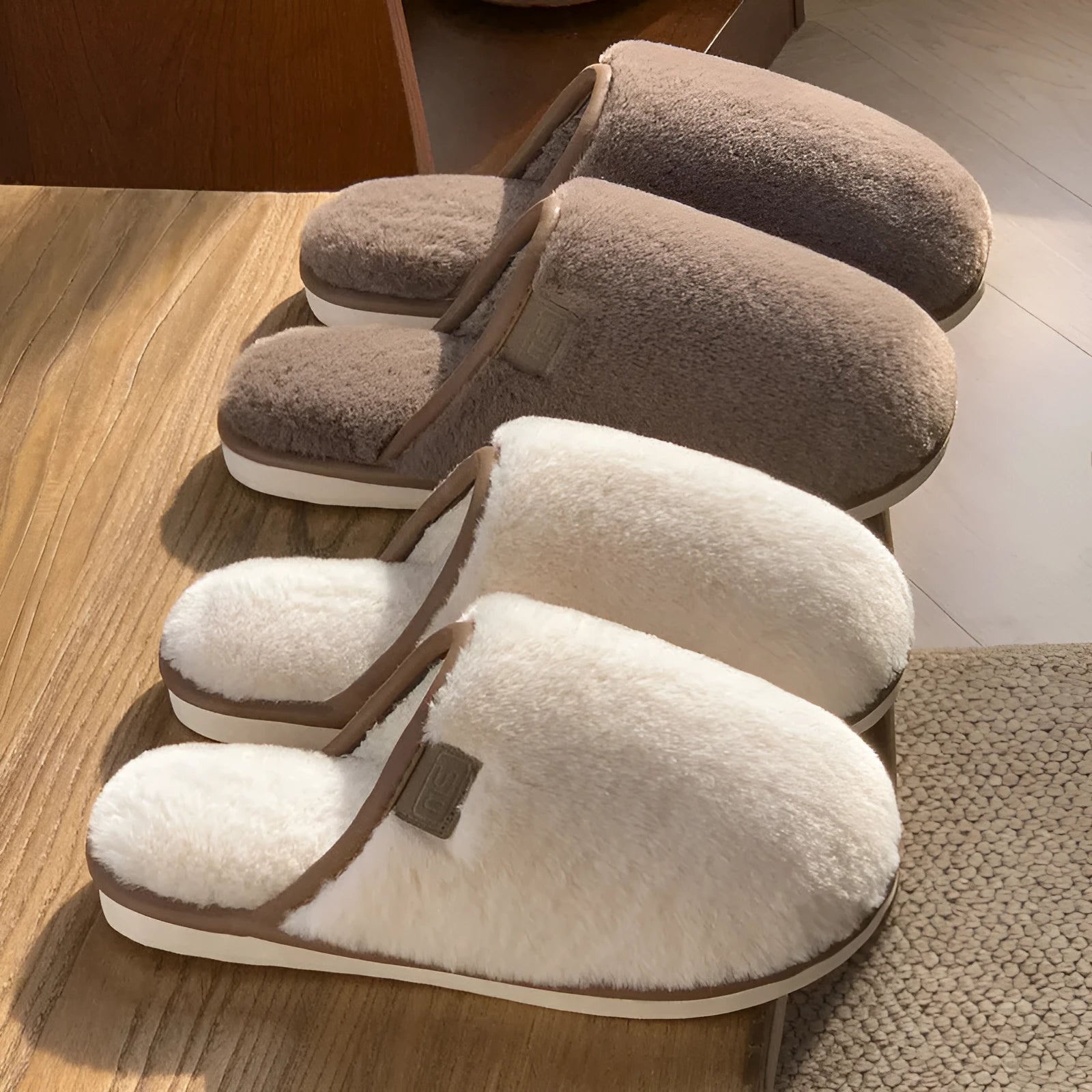 Blue plush slipper with non-slip PVC sole and car-stitching detail on a wooden floor.