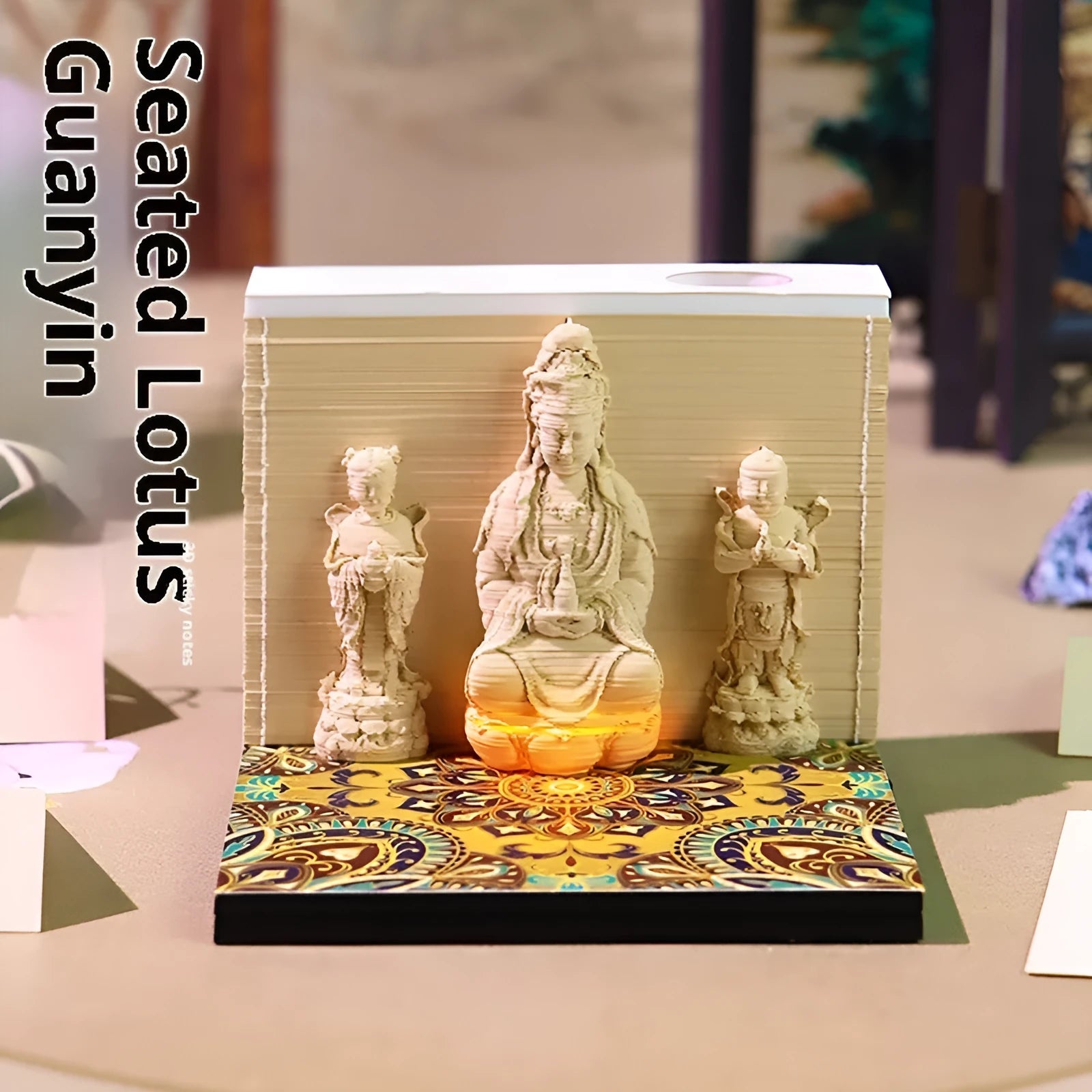 3D paper carving calendar 2026 showing Guanyin Bodhisattva and Sends Wealth Boy in seated lotus design, retro style