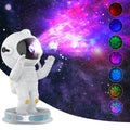 Exit Astronaut Starlight Projection Lamp in white with USB cable and remote control on a table