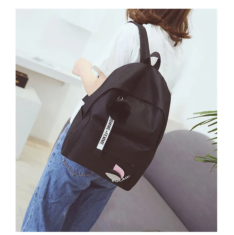 College style canvas rucksack in green with leaf pattern, showing anti-theft features and shoulder straps
