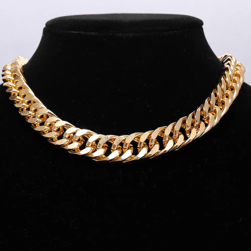 Gold coloured women's thick chain necklace on a white background.