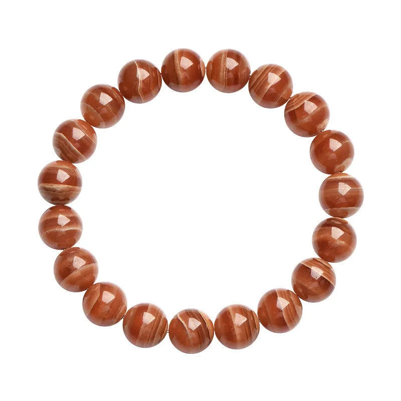 Natural old mine rhodochrosite round bead bracelet on wrist, showing geometric design and Ruyi symbol.