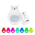 White silicone bear-shaped night light with remote control on a bedside table.