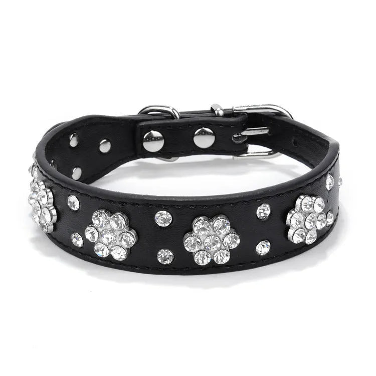 A studded rhinestone flower pattern on a soft black PU leather dog collar with a metal D-ring.