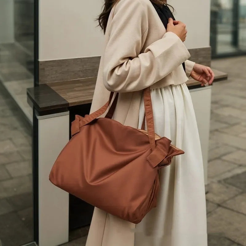 Women's black expandable shoulder crossbody bag made from Oxford cloth for travel and daily use.