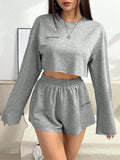 Women's grey long-sleeved t-shirt and shorts matching polyester set laid flat showing both pieces