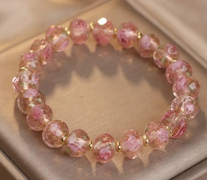 Colour changing artificial crystal bracelet with rose heart design in lake blue finish against a light background