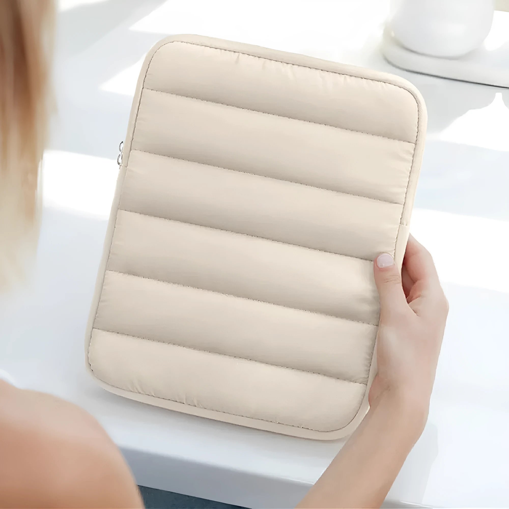 Fluffy black laptop sleeve with air puff padding for a 9.7-11 inch tablet, showing elastic edges.