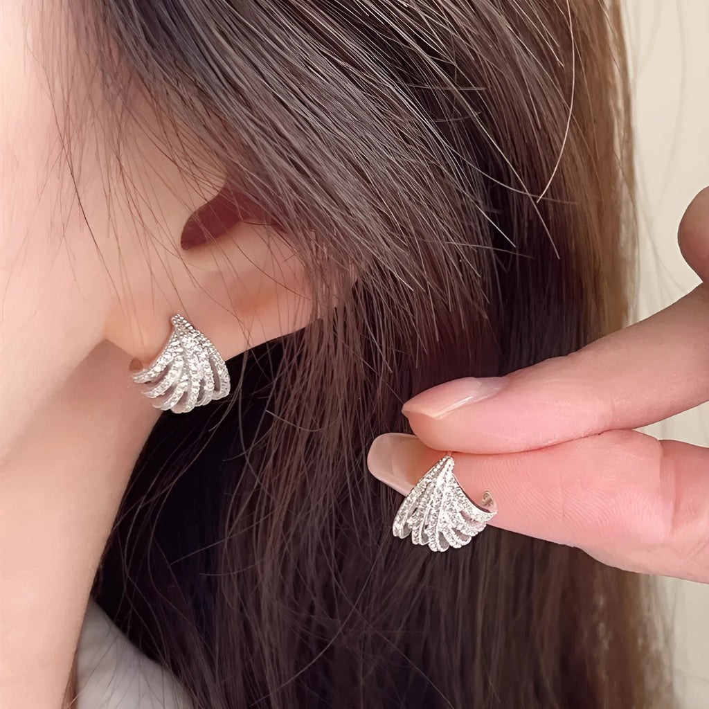 A pair of geometric drop earrings with a platinum electroplated finish on zircon.