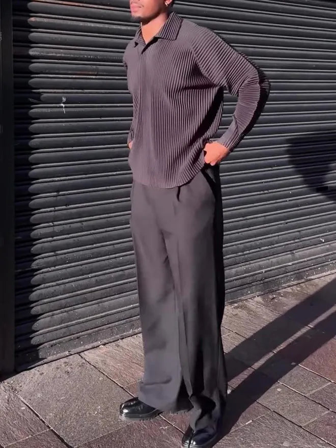 Men's black long-sleeved casual top with a pleated design detail.