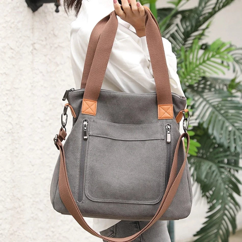 Women's canvas shoulder bag in multiple colours, showcasing spacious interior and zipper closure.
