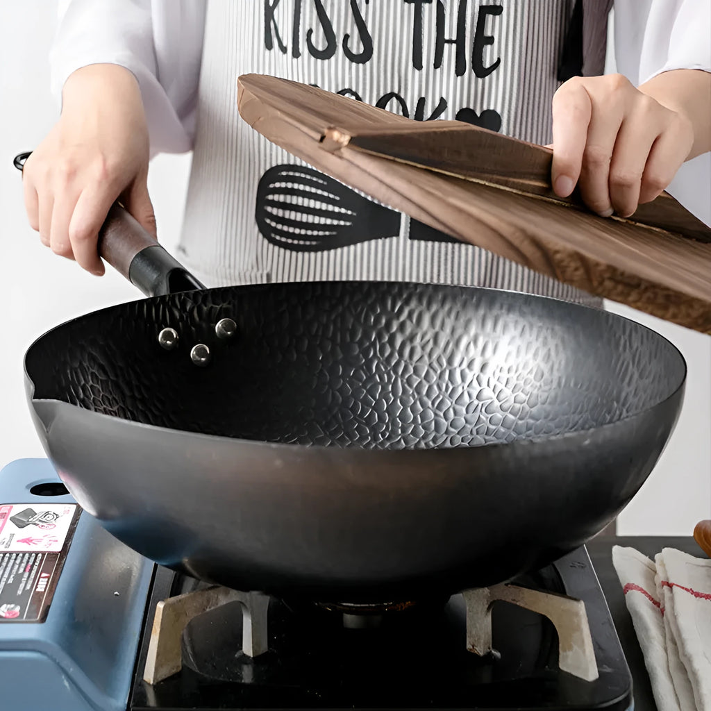 Traditional black iron wok pan with wooden handle measuring 40x32x10cm