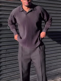 Men's black long-sleeved casual top with a pleated design detail.