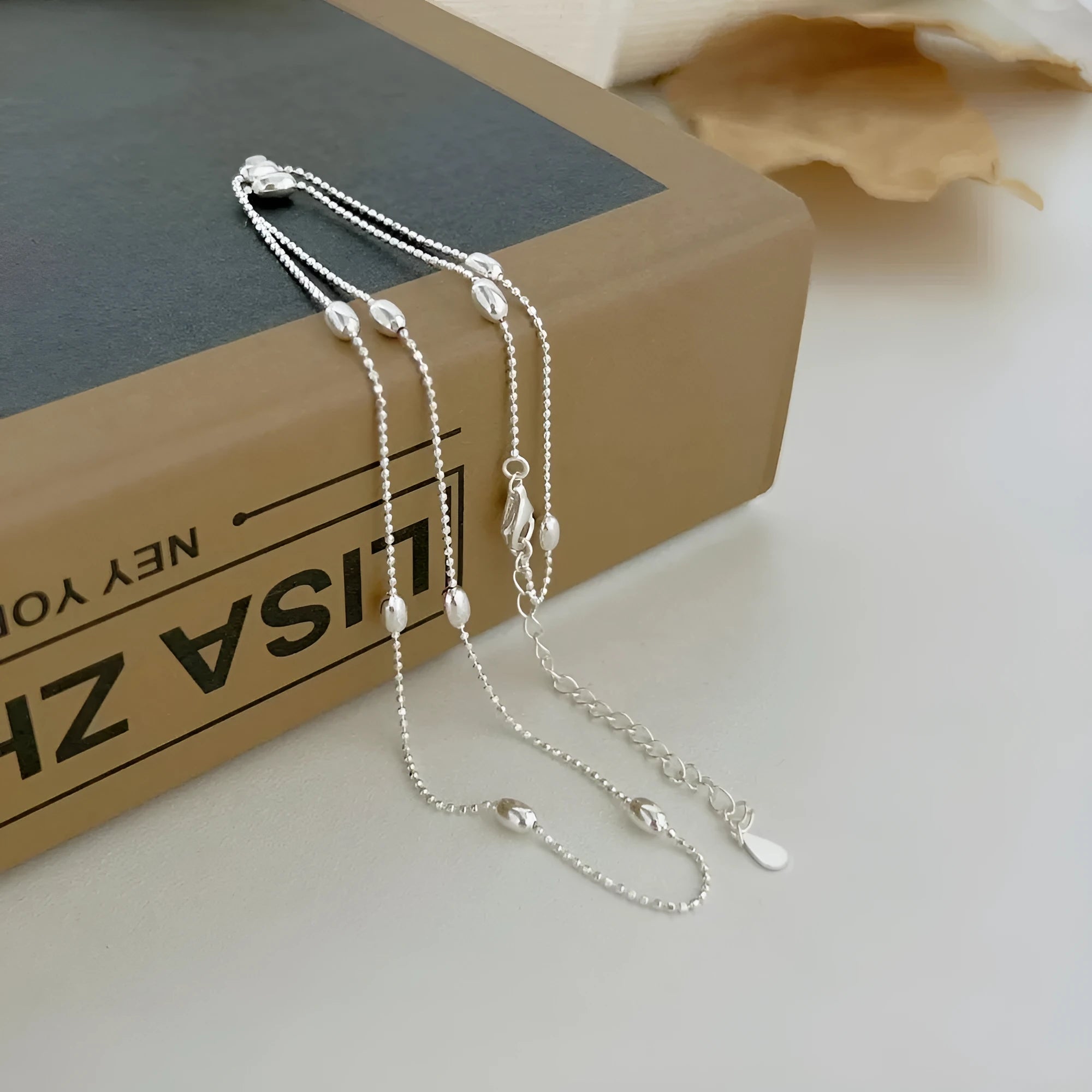 Women's 925 silver oval bead clavicle chain, simple electroplated finish, silver colour necklace on display